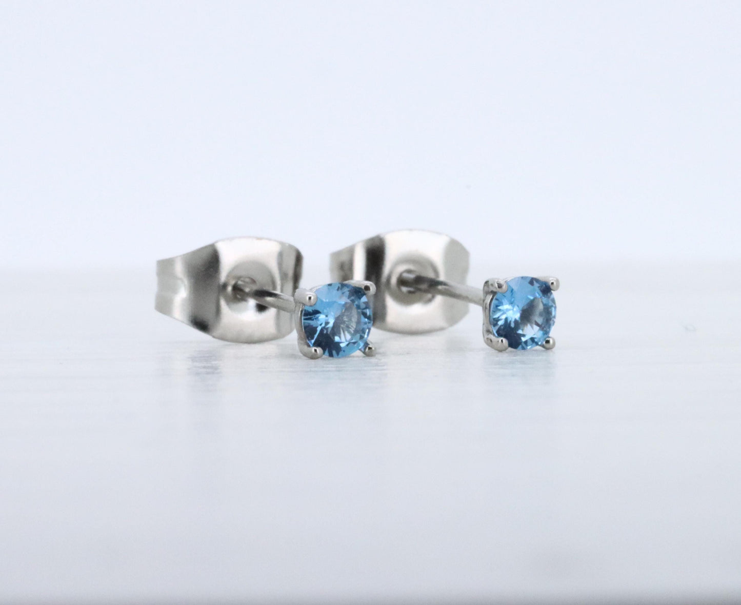 3mm Natural aquamarine stud earrings, available in titanium, white gold and surgical steel
