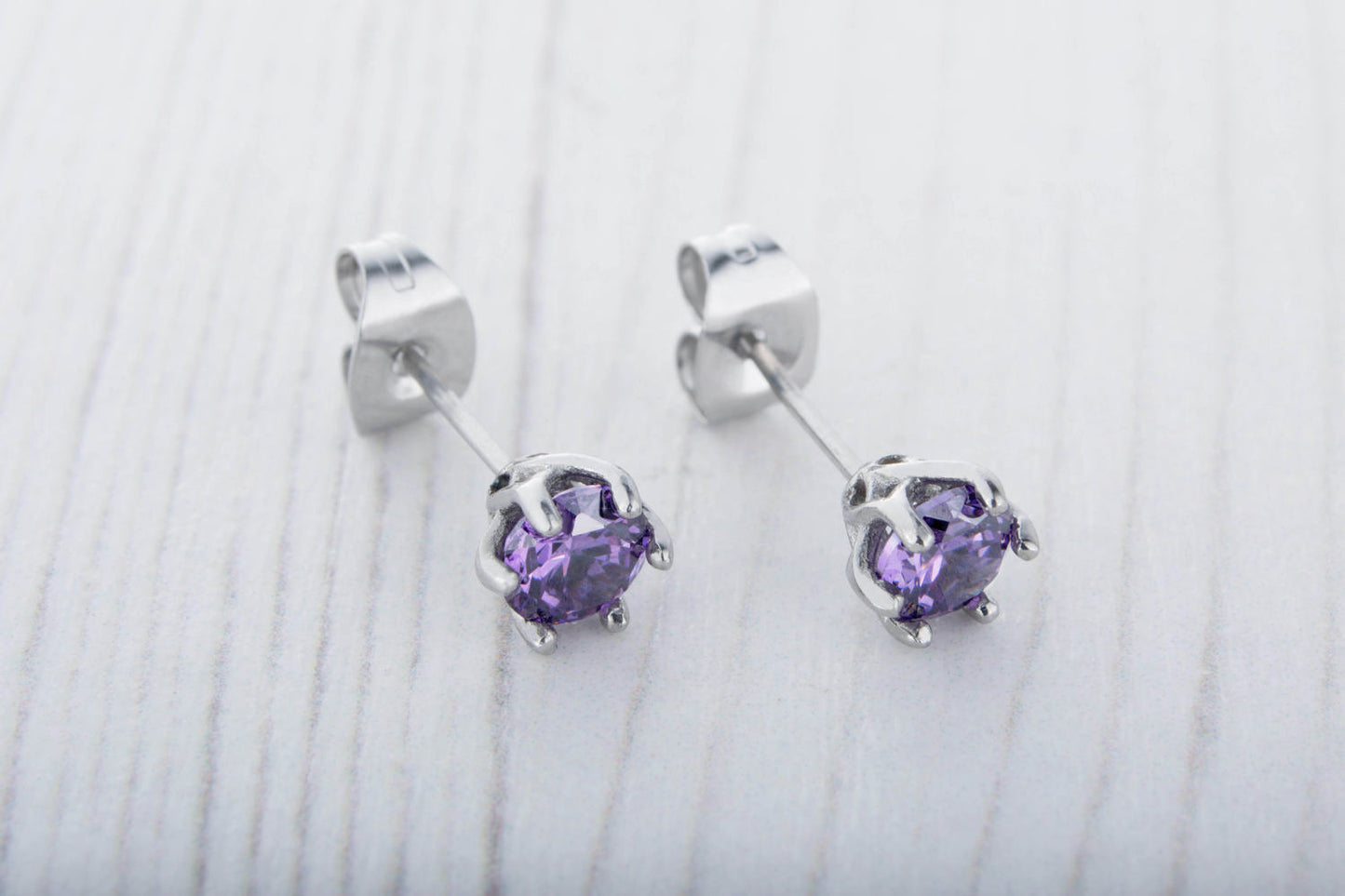 Natural Amethyst stud earrings, available in titanium, white gold and surgical steel 4mm amd 5mm sizes