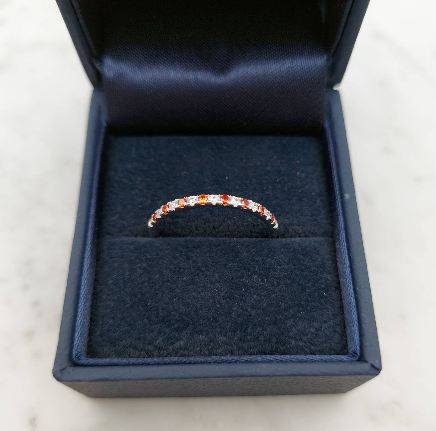 1.8mm wide Garnet and diamond Half Eternity ring