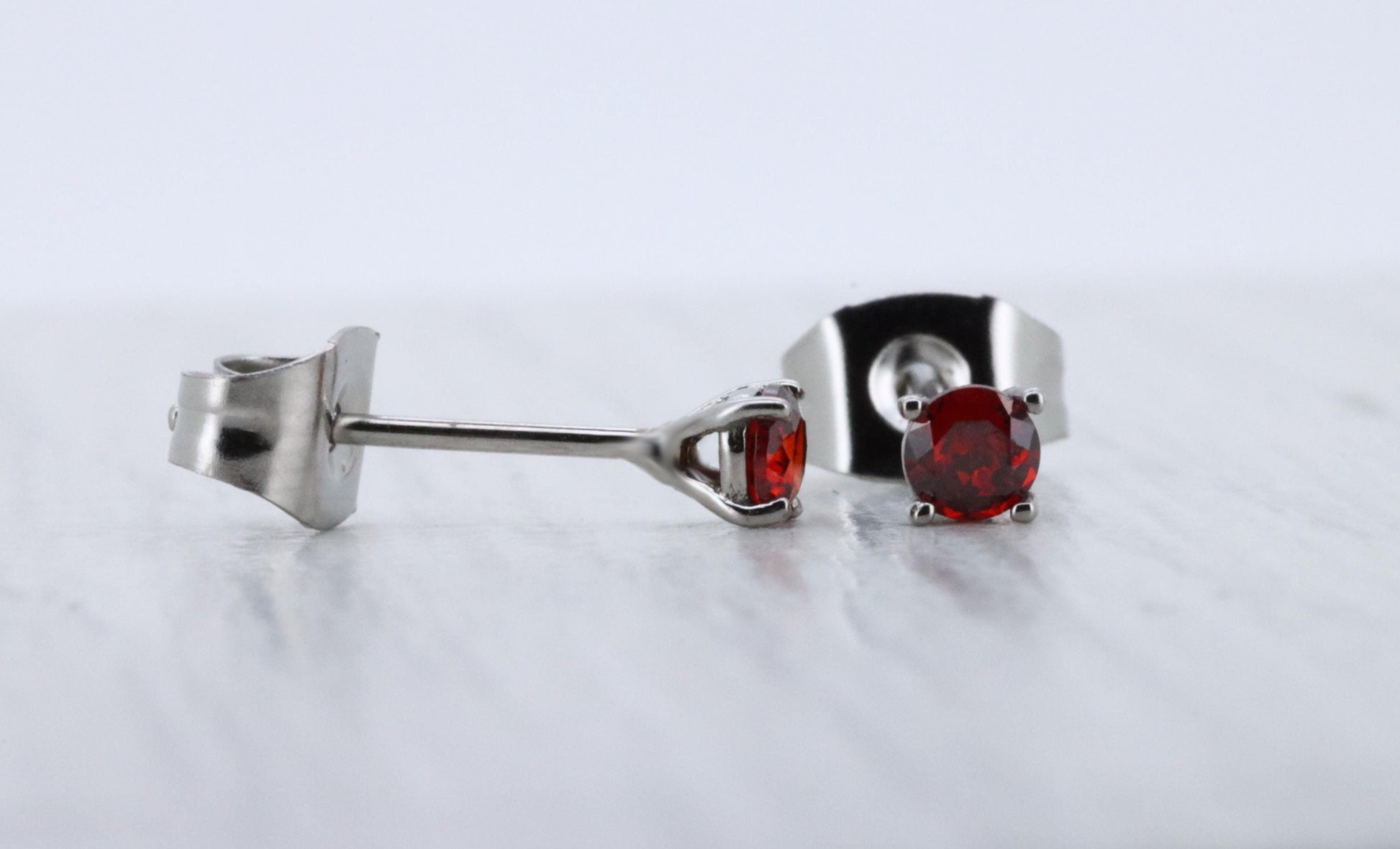 3mm Natural Garnet stud earrings, available in titanium, white gold and surgical steel