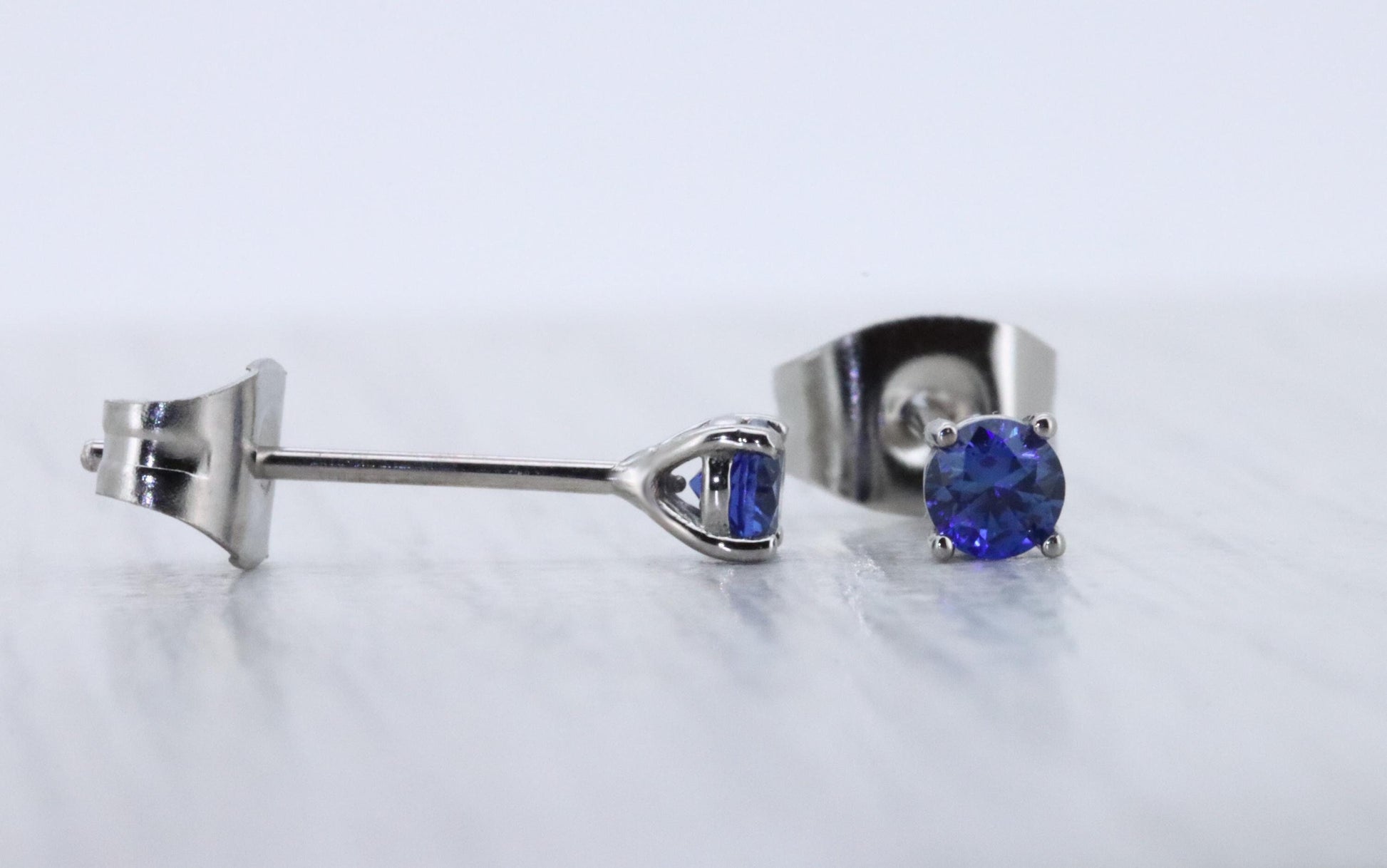 3mm Lab blue sapphire stud earrings, available in titanium, white gold and surgical steel