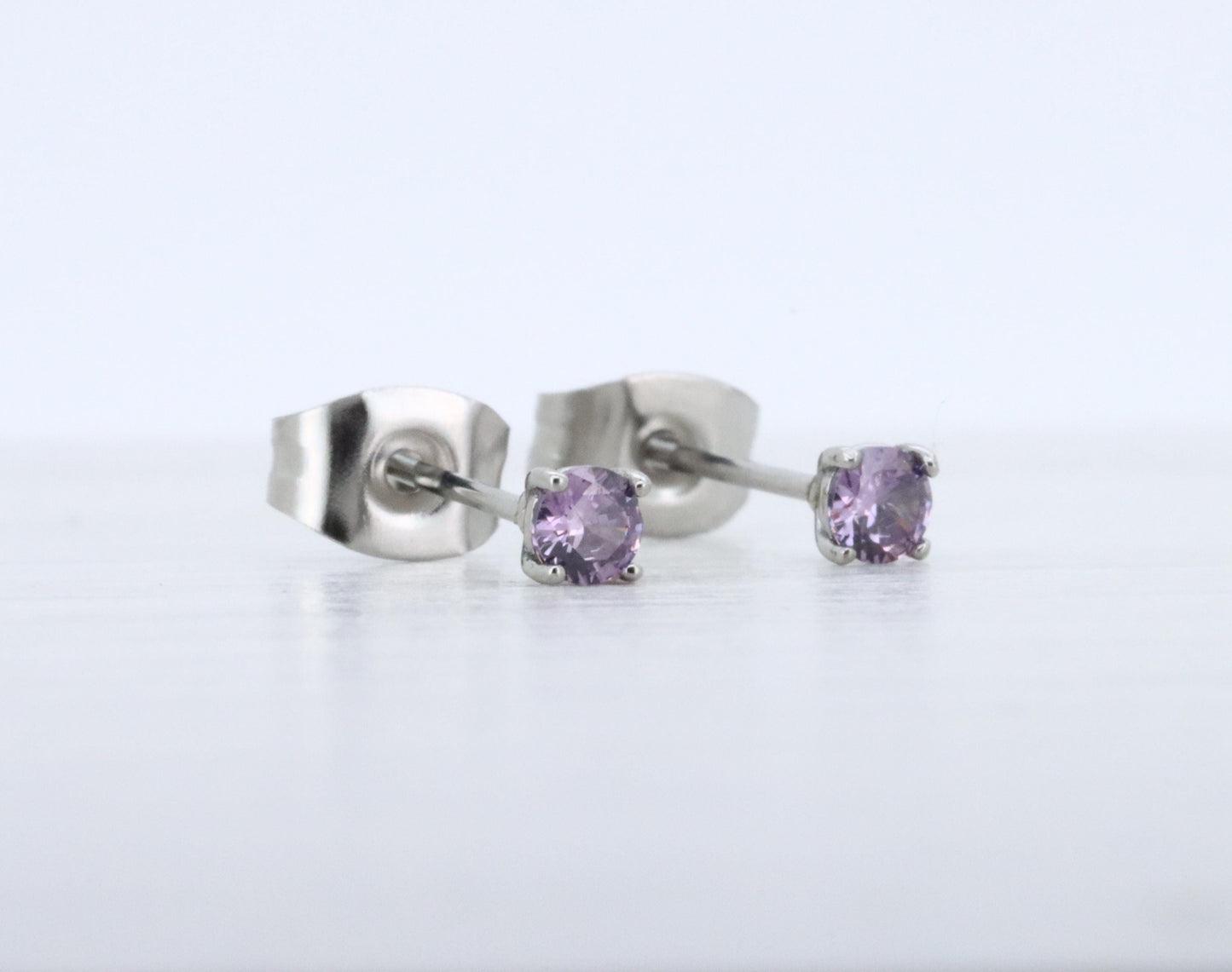 3mm Natural Amethyst stud earrings, available in titanium, white gold and surgical steel