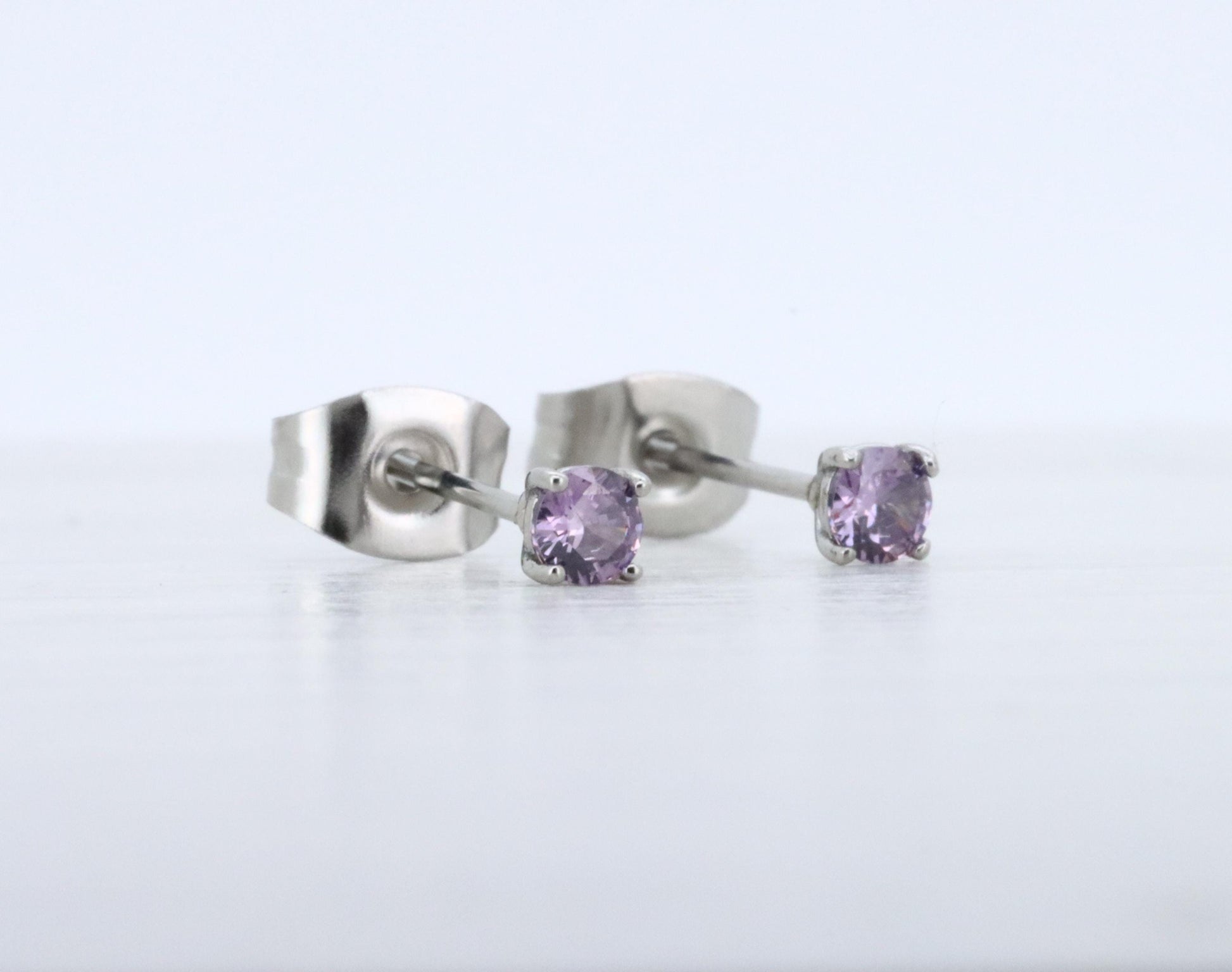 3mm Natural Amethyst stud earrings, available in titanium, white gold and surgical steel