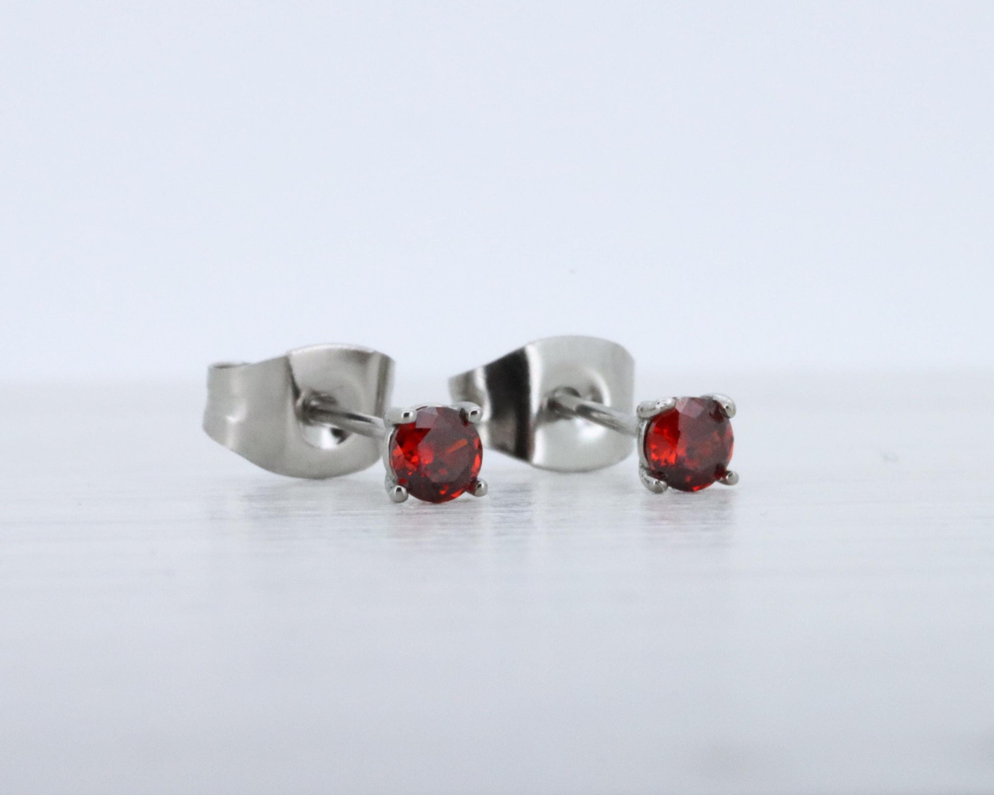 3mm Natural Garnet stud earrings, available in titanium, white gold and surgical steel