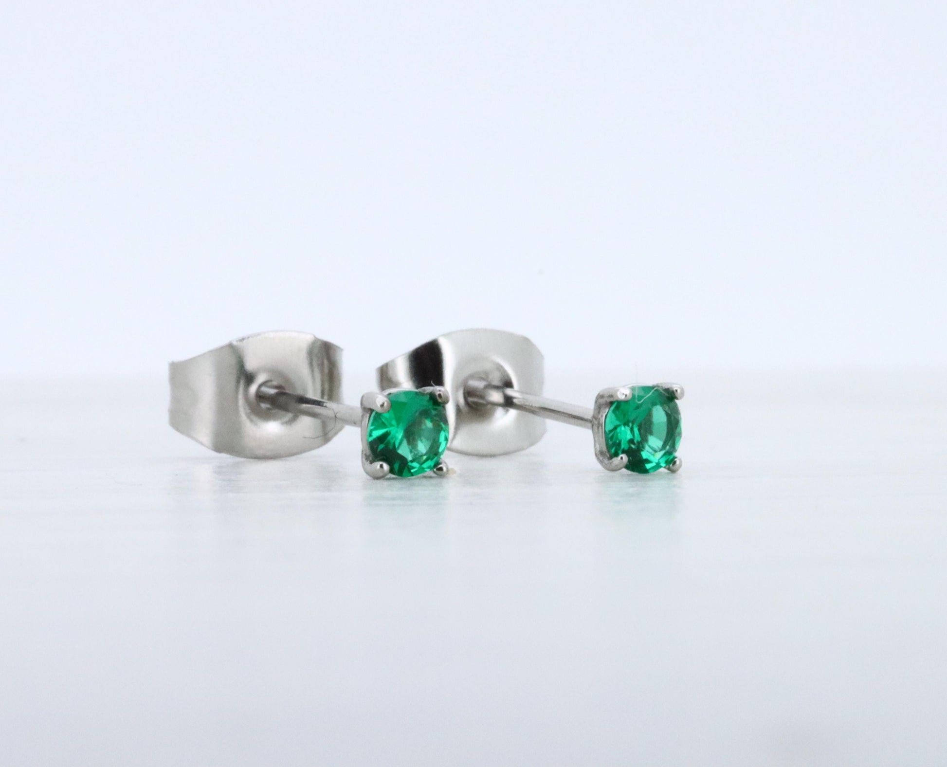 3mm Lab emerald stud earrings, available in titanium, white gold and surgical steel