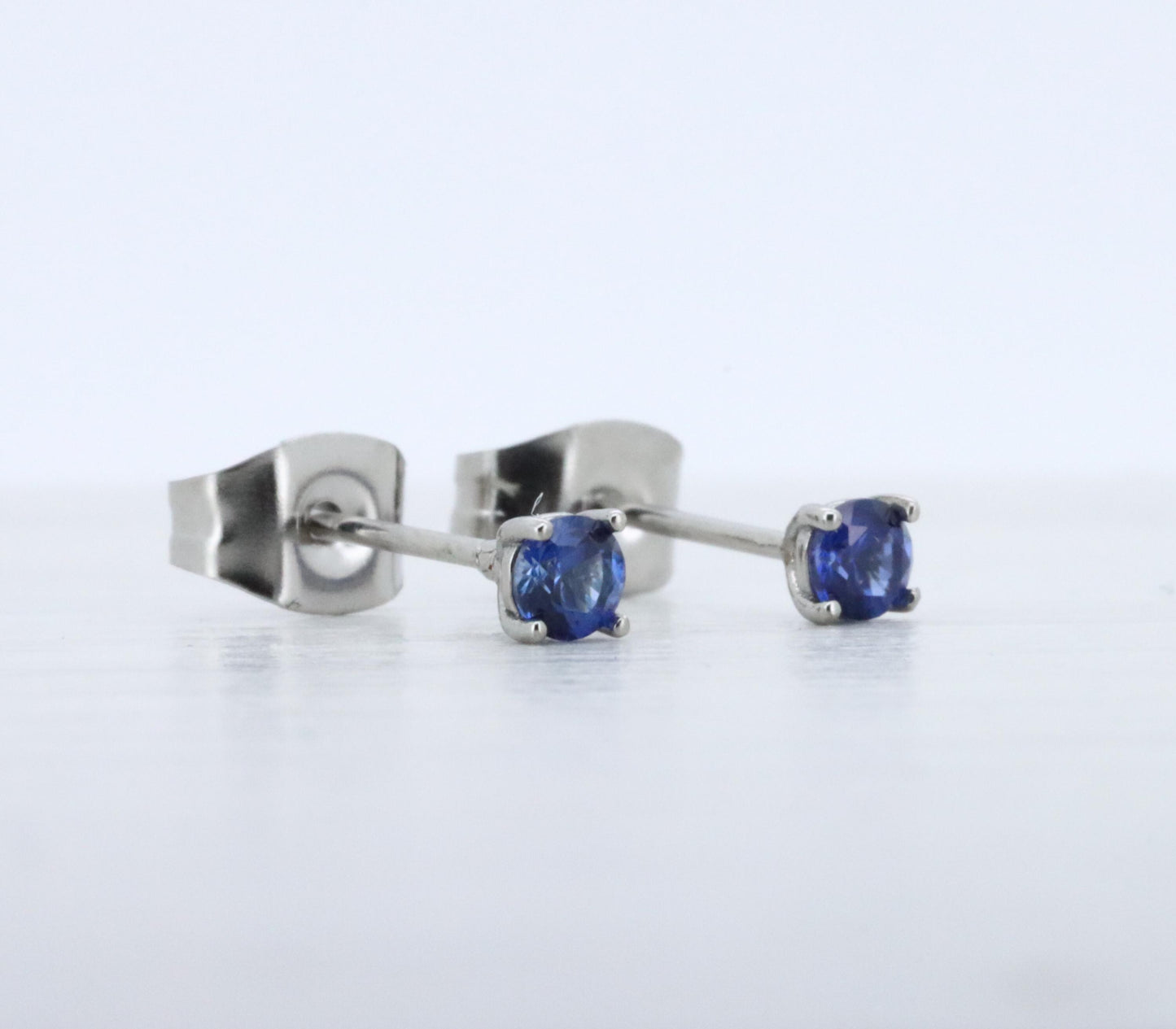 3mm Lab blue sapphire stud earrings, available in titanium, white gold and surgical steel