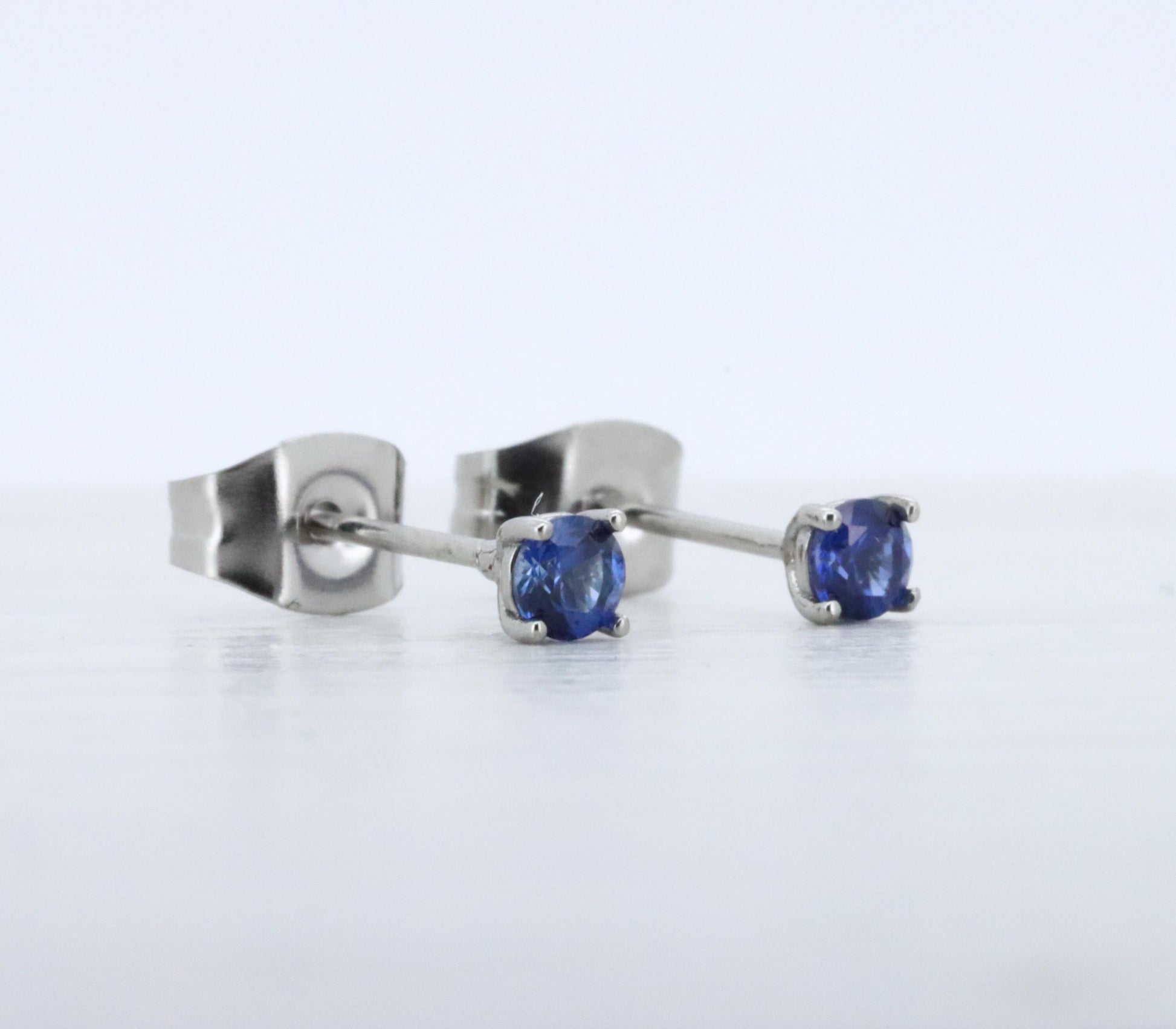 3mm Lab blue sapphire stud earrings, available in titanium, white gold and surgical steel