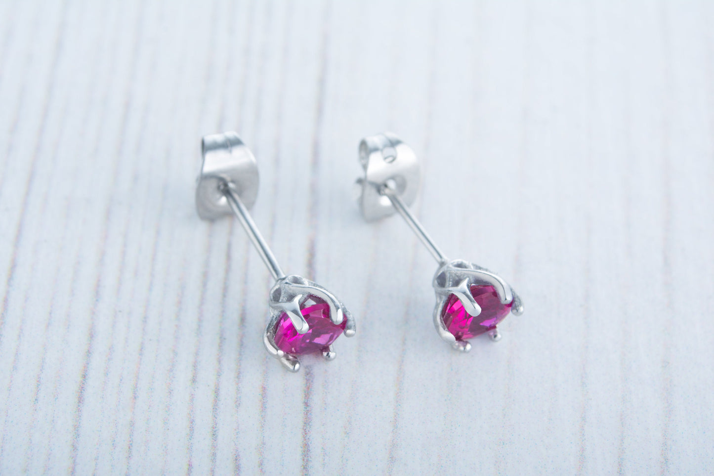 Lab Ruby stud earrings, available in titanium, white gold and surgical steel 4mm, 5mm and 6mm sizes