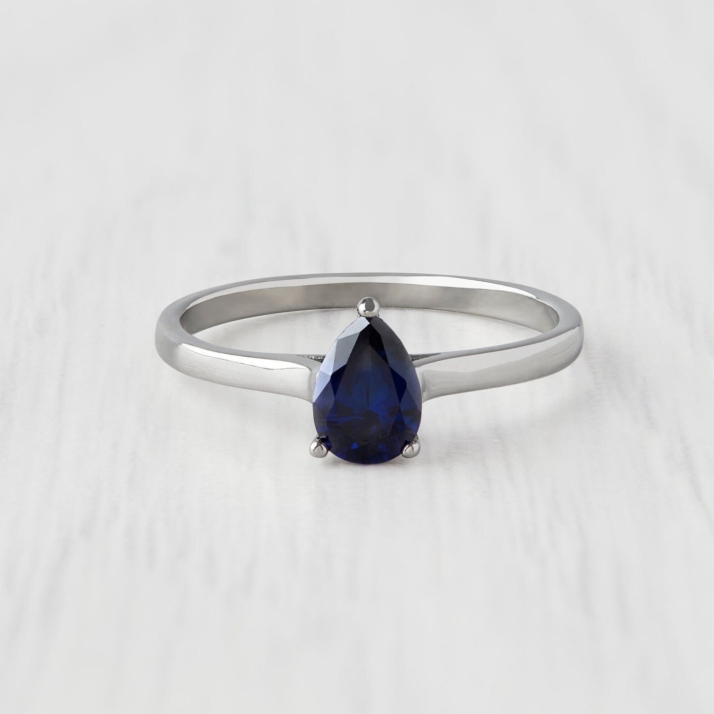0.7ct Pear Cut Lab Blue Sapphire Solitaire cathedral ring in Titanium or White Gold